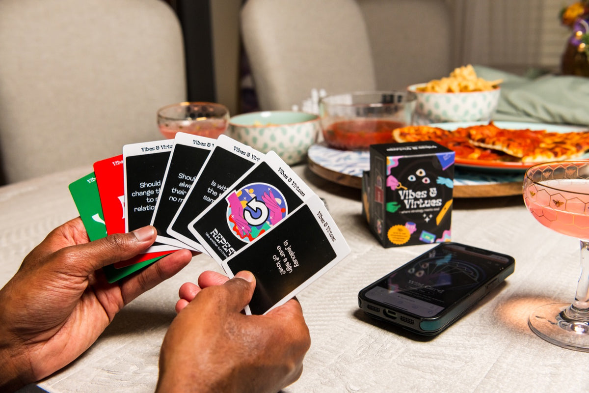 After Dark cards in hand at a table set for a night with friends